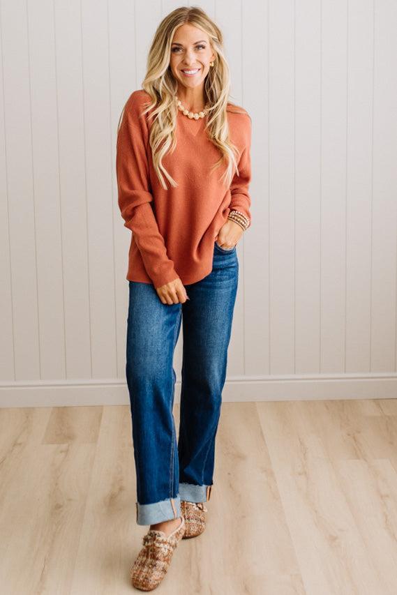 Blonde woman wearing a solid waffle texture sweater with drop shoulder seams and crewneck.
