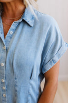 Light blue denim shirt worn by a person on a neutral background