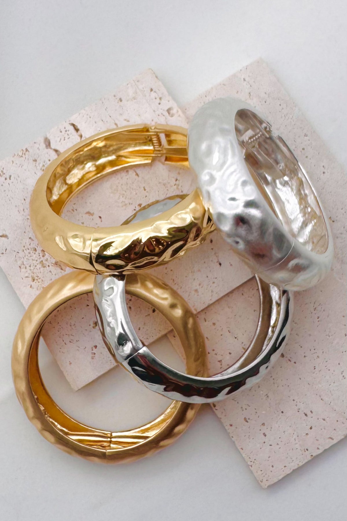 Pile of mixed metal bangle bracelets.