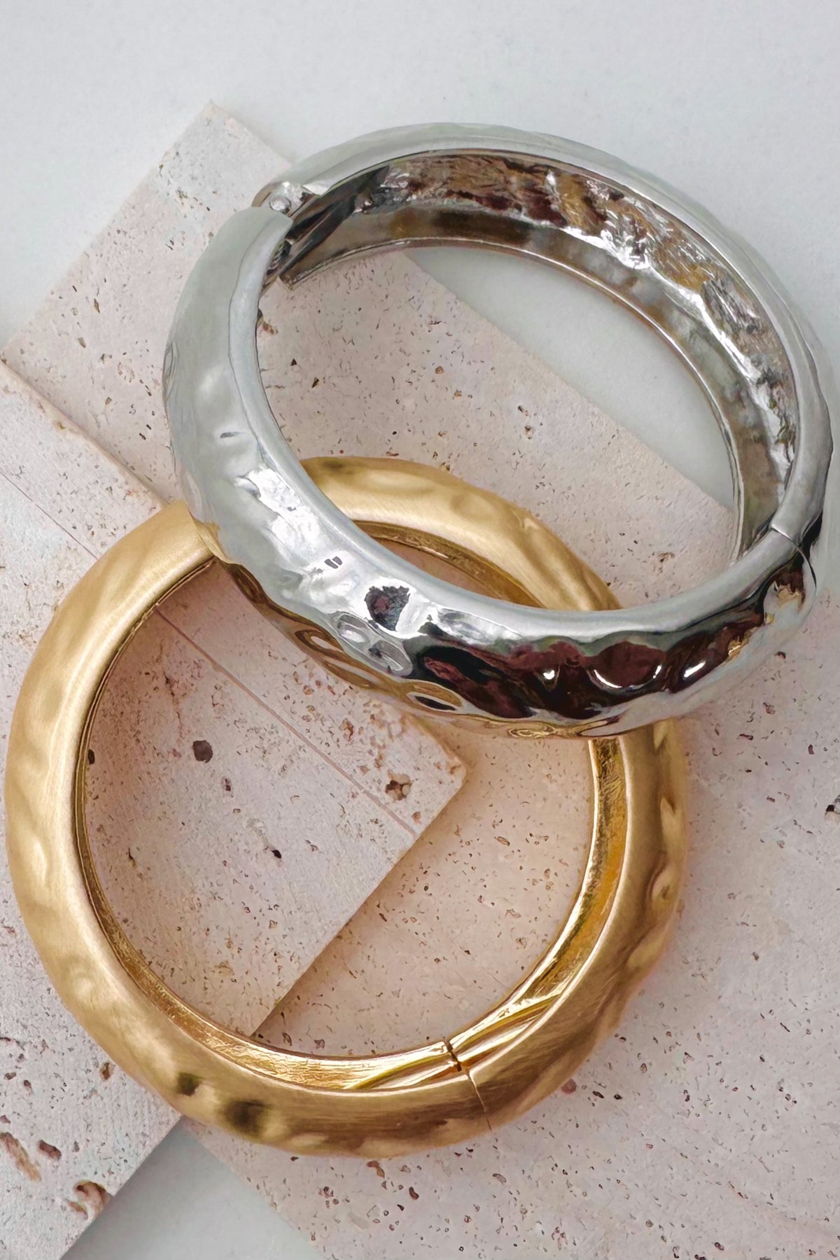 Pile of mixed metal bangle bracelets.