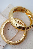 Pile of mixed metal bangle bracelets.