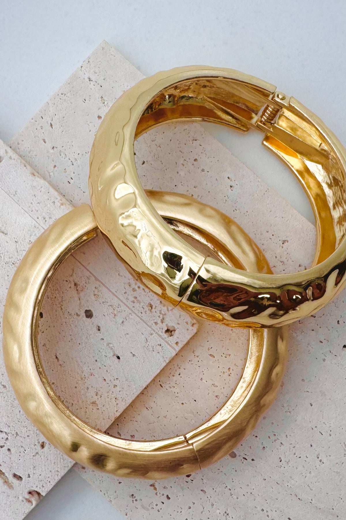 Pile of mixed metal bangle bracelets.