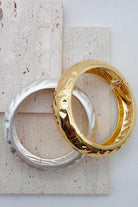 Pile of mixed metal bangle bracelets.