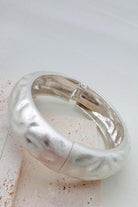 Pile of mixed metal bangle bracelets.