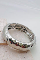 Pile of mixed metal bangle bracelets.