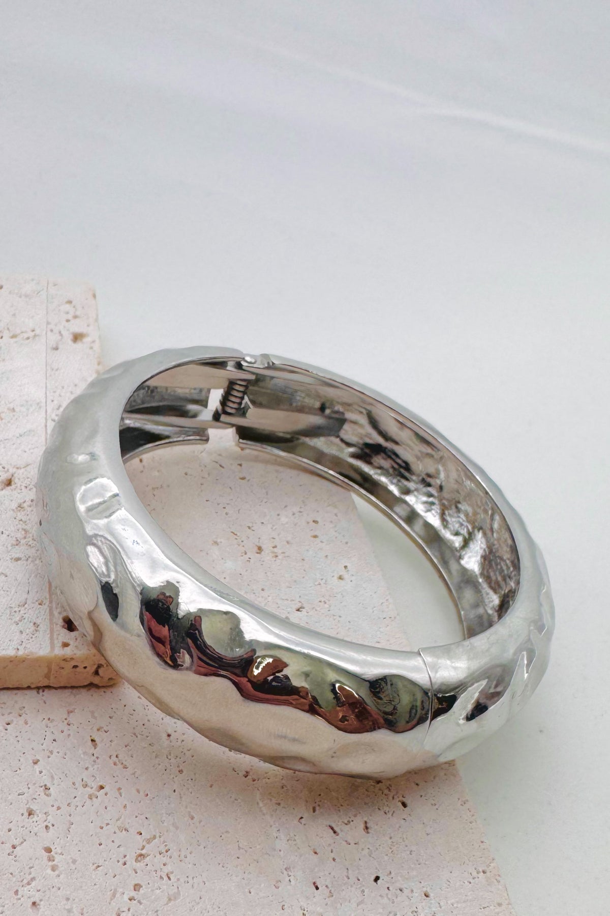 Pile of mixed metal bangle bracelets.