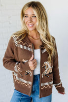Woman wearing a brown patterned cardigan against a white background