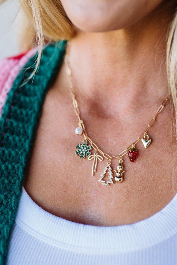 Necklace with various charms worn by a person