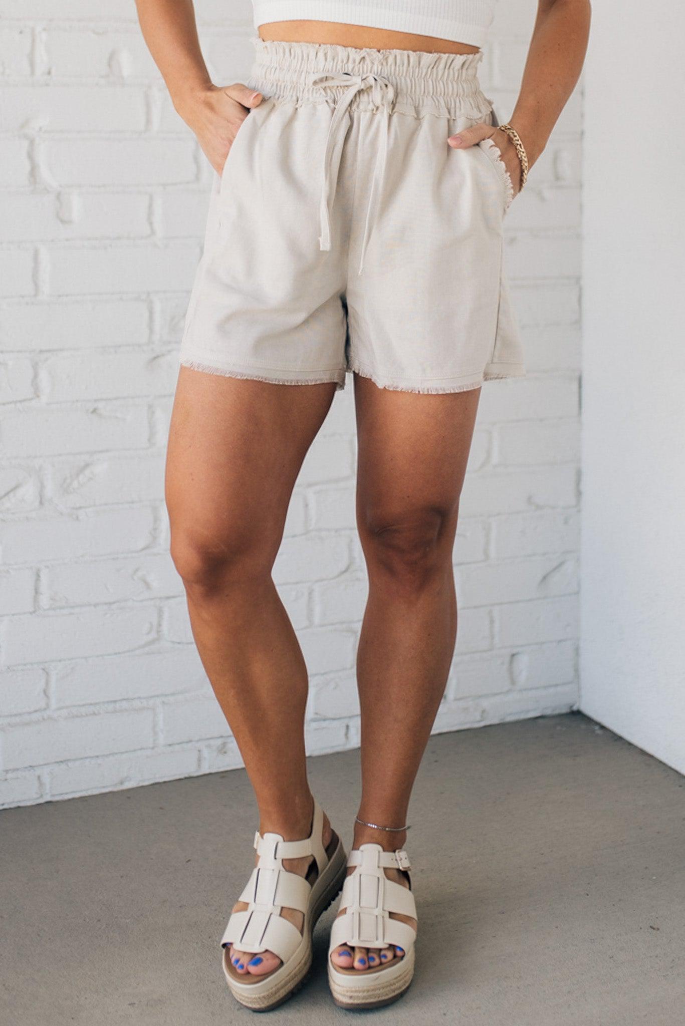 Linen blend natural color shorts with drawstring waist band and smocked detail.