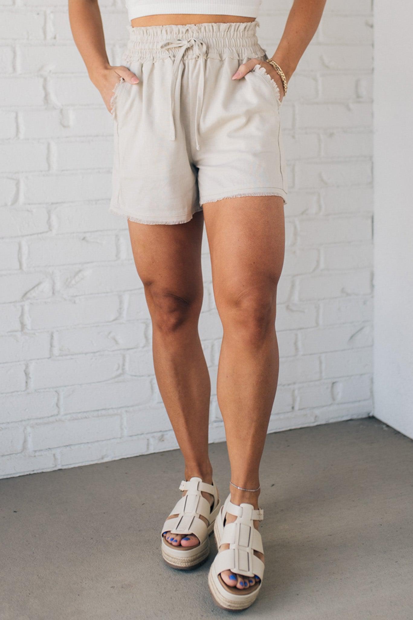 Linen blend natural color shorts with drawstring waist band and smocked detail.