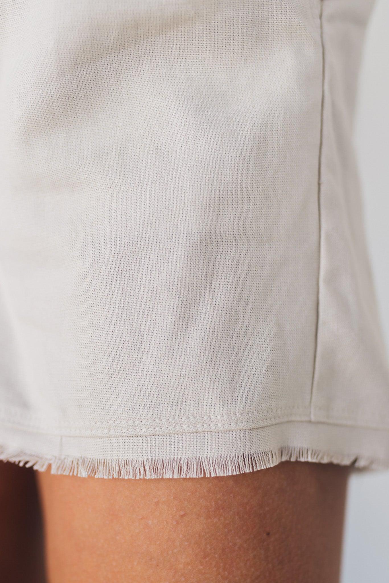 Linen blend natural color shorts with drawstring waist band and smocked detail.
