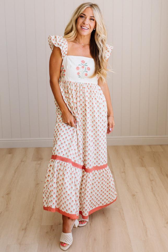 Woman wearing a floral dress with a white background