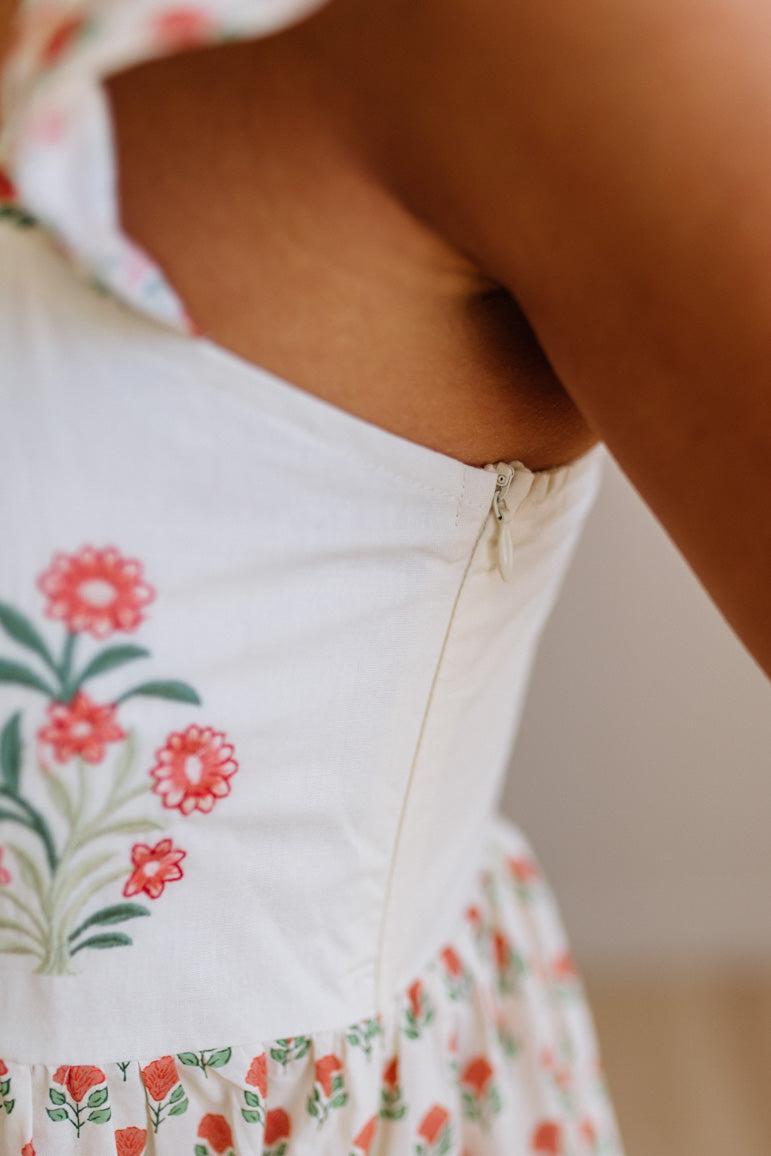 Close-up of a white garment with floral embroidery on a blurred background