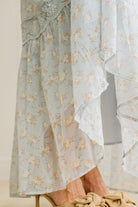 Close Up of Hem Line Of a Light Blue Floral Lace Paneled Maxi Dress.