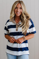 Woman wearing a blue and white striped shirt with a neutral background