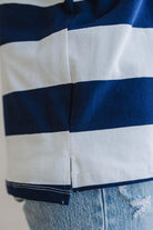 Close-up of a blue and white striped shirt with a blurred background