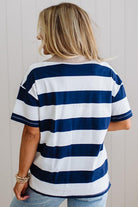 Person wearing a blue and white striped shirt against a plain background