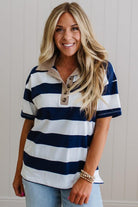 Woman wearing a navy and white striped shirt with a beige collar.
