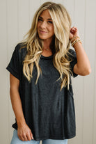 Woman wearing a black t-shirt with a neutral background