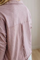 Close-up of a pink shirt worn by a person with a neutral background