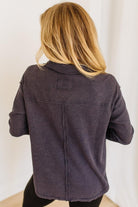 Woman wearing a navy waffle top against a white background