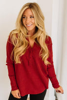 Woman wearing a red top against a white background