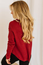 Woman wearing a red top against a white background