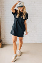 Blonde Woman Wearing a Black Premium Cotton T-shirt Dress With Pockets.