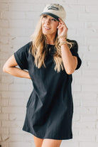Blonde Woman Wearing a Black Premium Cotton T-shirt Dress With Pockets.