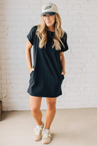 Blonde Woman Wearing a Black Premium Cotton T-shirt Dress With Pockets.