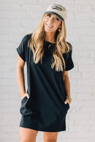 Blonde Woman Wearing a Black Premium Cotton T-shirt Dress With Pockets.