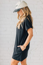 Blonde Woman Wearing a Black Premium Cotton T-shirt Dress With Pockets.