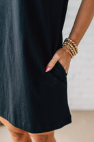 Blonde Woman Wearing a Black Premium Cotton T-shirt Dress With Pockets.