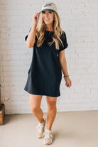 Blonde Woman Wearing a Black Premium Cotton T-shirt Dress With Pockets.