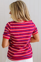 Person wearing a red and blue striped shirt against a white background
