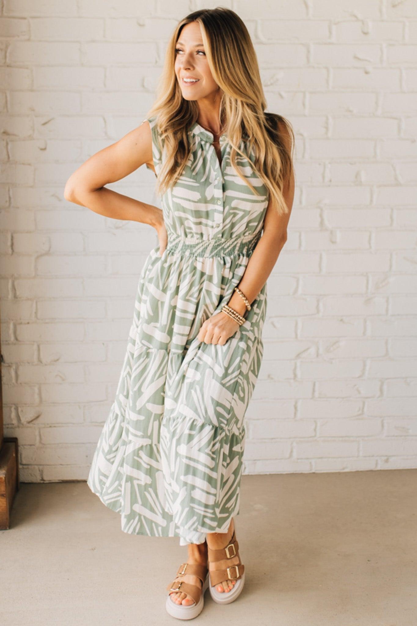 Blonde Woman Wearing a Button Up Sleeveless Smocking Waist Abstract Dress.