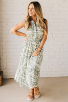 Blonde Woman Wearing a Button Up Sleeveless Smocking Waist Abstract Dress.