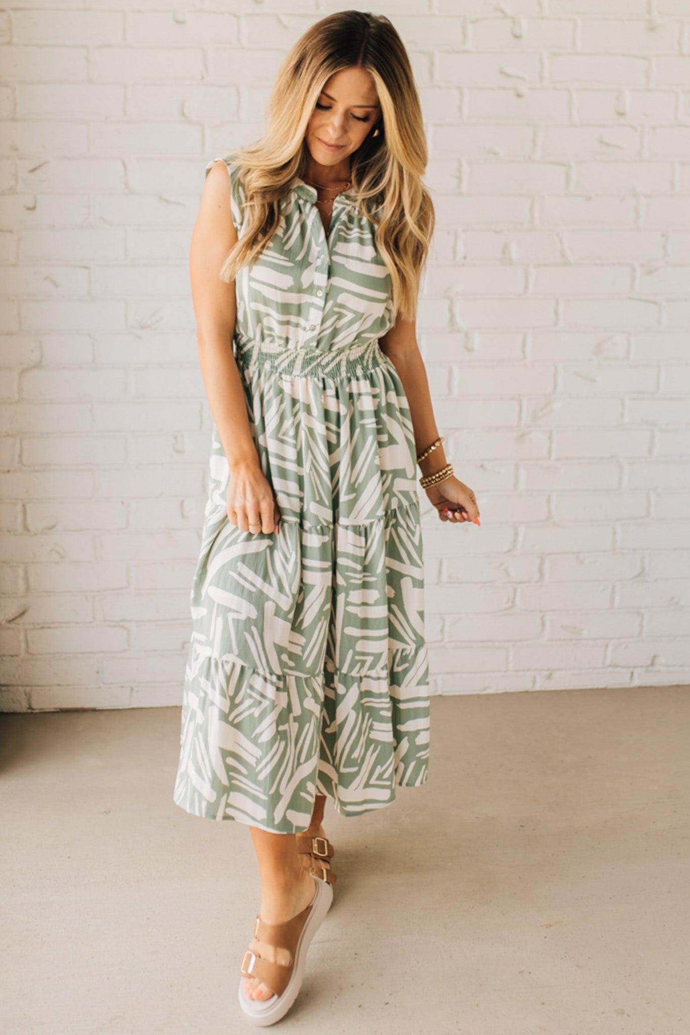 Blonde Woman Wearing a Button Up Sleeveless Smocking Waist Abstract Dress.