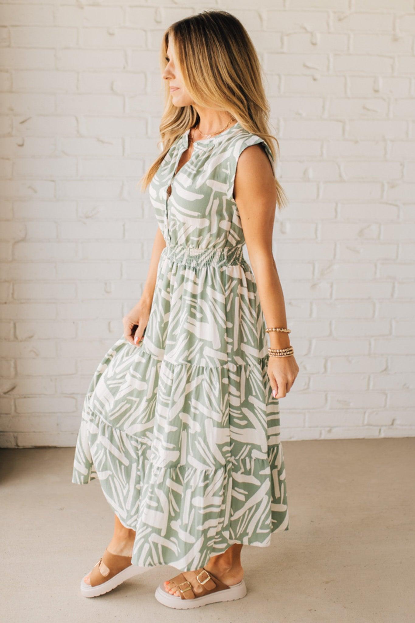 Blonde Woman Wearing a Button Up Sleeveless Smocking Waist Abstract Dress.
