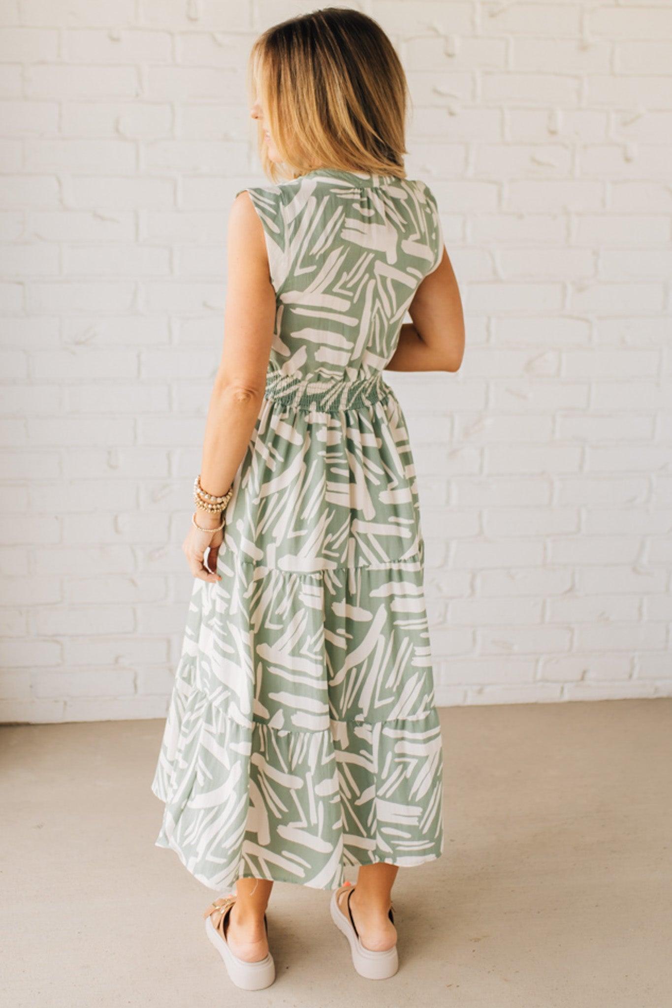 Blonde Woman Wearing a Button Up Sleeveless Smocking Waist Abstract Dress.