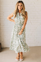 Blonde Woman Wearing a Button Up Sleeveless Smocking Waist Abstract Dress.