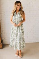 Blonde Woman Wearing a Button Up Sleeveless Smocking Waist Abstract Dress.