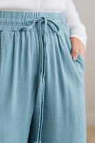 Light blue pants with a drawstring waist worn by a person.