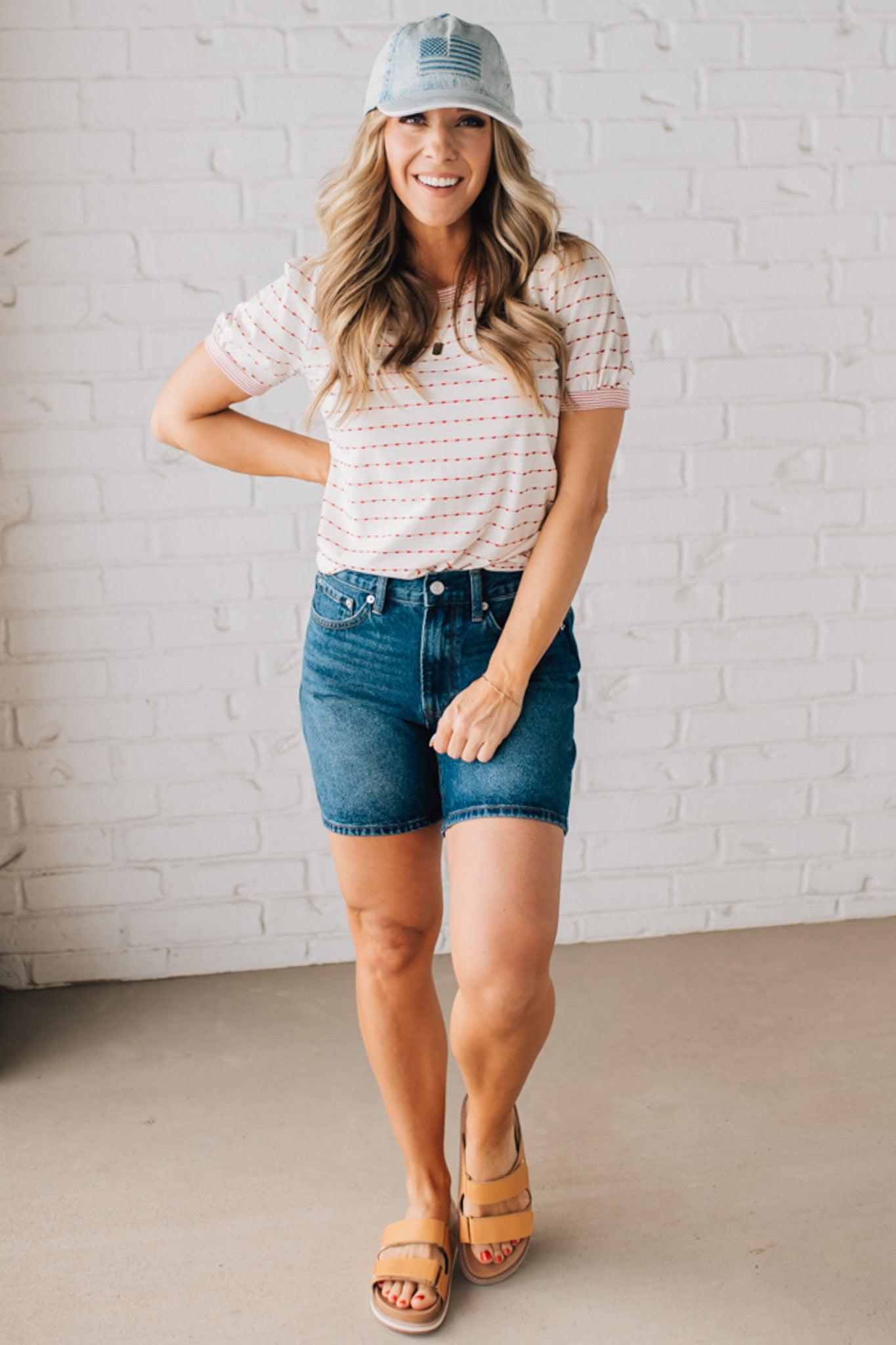 BLONDE WOMAN WEARING A STRIPE CONTRAST TRIMMED, PUFF SHORT SLEEVE, DOTTED STRIPE TOP IN WHITE AND RED.