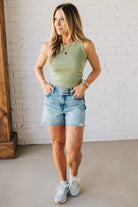 Woman wearing Acid Washed Raw Hem Shorts in Mid Rise.