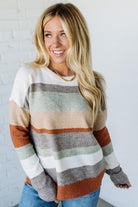 Woman wearing a striped sweater against a white background
