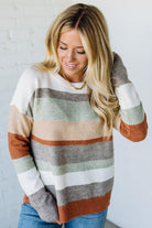 Woman wearing a striped sweater with a white background