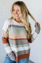 Woman wearing a striped sweater with a white background