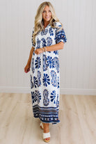 Blonde woman wearing a Printed Smocked Yoke Midi Dress with Short Balloon Sleeves
