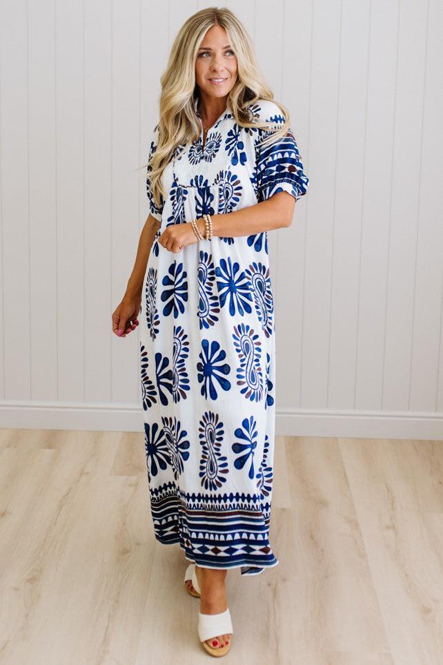 Blonde woman wearing a Printed Smocked Yoke Midi Dress with Short Balloon Sleeves
